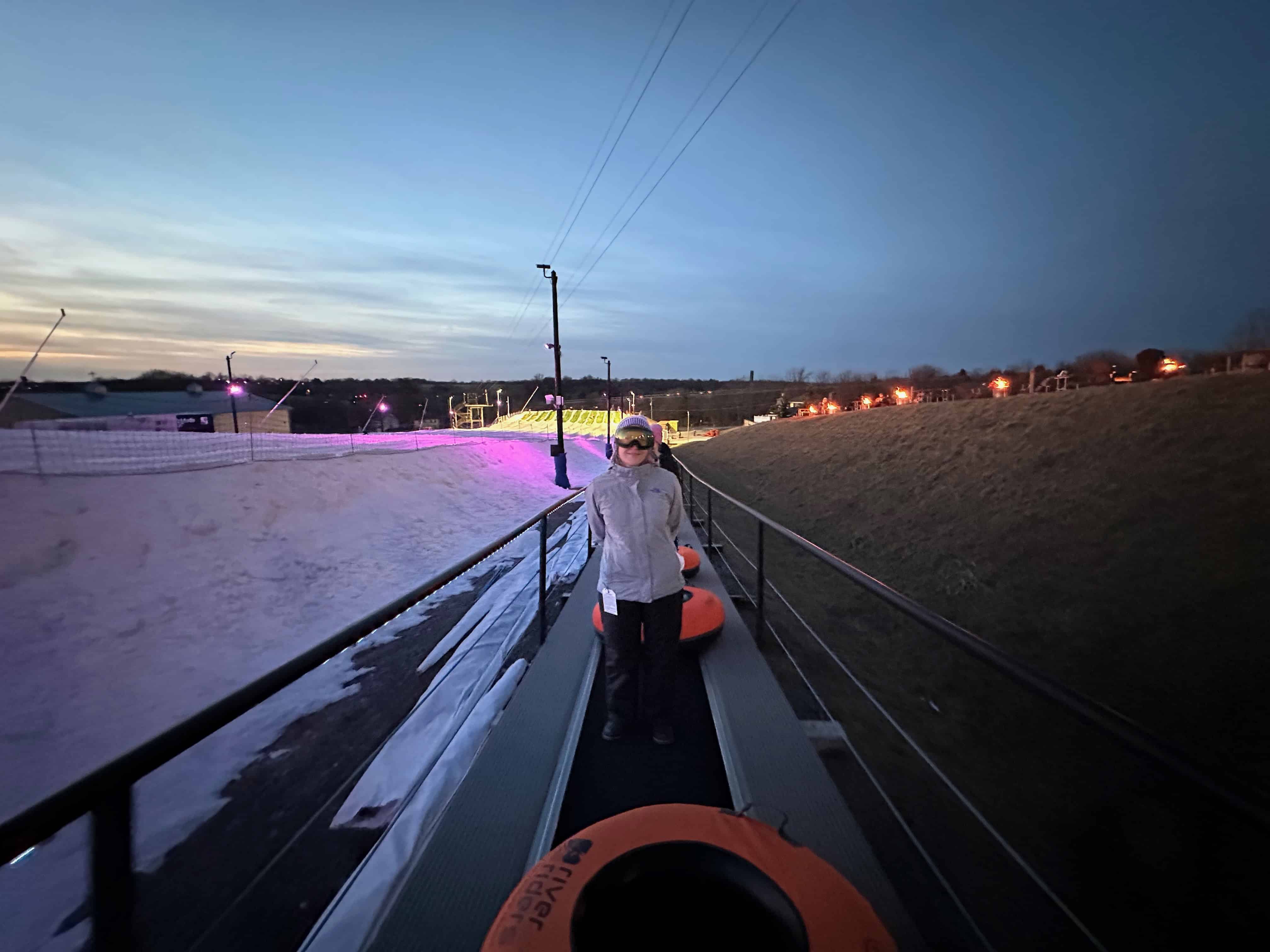 Riding the magic carpet back to the top of the hill.