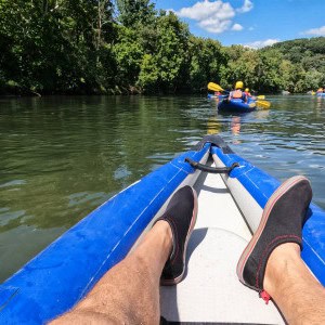 POV of calm water while kayaking